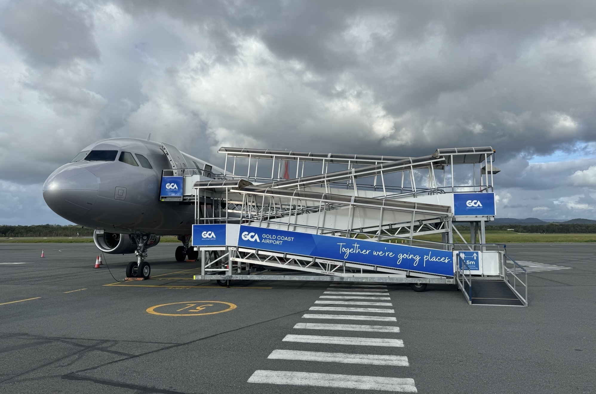 Passengers boarding a Jetstar aircraft via a ramp